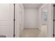 Hallway area featuring neutral carpet, white walls, white trim, and white doors at 12029 Conrad Circle, Hampton, GA 30228