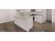 Kitchen island with granite countertop, stainless steel appliances and hardwood floors at 12029 Conrad Circle, Hampton, GA 30228
