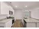 Modern kitchen with stainless steel appliances and granite countertops with hardwood floors at 12029 Conrad Circle, Hampton, GA 30228