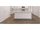 Modern kitchen featuring an island with a sink and granite countertops at 12029 Conrad Circle, Hampton, GA 30228
