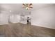 Open-concept living room flows into kitchen with hardwood floors and a ceiling fan at 12029 Conrad Circle, Hampton, GA 30228
