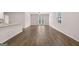 Open living room and kitchen area featuring hardwood floors and ample natural light at 12029 Conrad Circle, Hampton, GA 30228