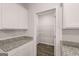 Pantry area with granite counter tops, shelves for storage and hardwood floors at 12029 Conrad Circle, Hampton, GA 30228