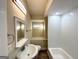 Updated bathroom with a white sink, bathtub, and tiled shower at 1996 Meadow Ln, Decatur, GA 30032