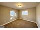 Well-lit bedroom with neutral walls, carpet flooring, and two windows at 2629 Preston Dr, Decatur, GA 30034
