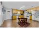 Galley kitchen with light wood cabinets, granite countertops, and a table for four at 304 Slaughter Rd, Hampton, GA 30228