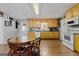Kitchen with light wood cabinets, granite countertops, and a small dining area at 304 Slaughter Rd, Hampton, GA 30228