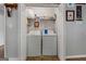 Convenient laundry room with washer and dryer, and shelving for supplies at 304 Slaughter Rd, Hampton, GA 30228