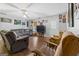 Bright living room with hardwood floors, comfy seating, and a ceiling fan at 304 Slaughter Rd, Hampton, GA 30228