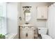 Charming bathroom featuring a vanity with a marble countertop and oval mirror at 12 Independence Nw Pl # 12, Atlanta, GA 30318
