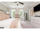 Bedroom with large windows offering natural light, ceiling fan, and carpeted floors at 12 Independence Nw Pl # 12, Atlanta, GA 30318