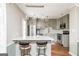 Open kitchen with stainless steel appliances, breakfast bar and modern pendant lighting at 12 Independence Nw Pl # 12, Atlanta, GA 30318