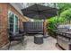 Inviting outdoor patio with grilling area, comfortable seating, and privacy fence at 12 Independence Nw Pl # 12, Atlanta, GA 30318