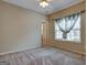 Spacious carpeted bedroom with ceiling fan and large window at 55 Clearbrook Ct, Covington, GA 30016