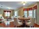 Elegant dining room featuring a round table and hardwood floors at 55 Clearbrook Ct, Covington, GA 30016