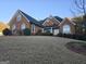 Brick home with a large front yard and a two-car garage at 55 Clearbrook Ct, Covington, GA 30016