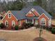 Brick house with gray roof, landscaping, and a long driveway at 55 Clearbrook Ct, Covington, GA 30016