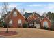 Brick home with a large front yard and mature trees at 55 Clearbrook Ct, Covington, GA 30016