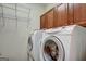 Bright laundry room, complete with washer, dryer, and ample storage at 55 Clearbrook Ct, Covington, GA 30016