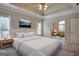 Bright main bedroom with plush bedding and access to a sitting area at 55 Clearbrook Ct, Covington, GA 30016