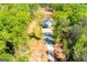 Areal view of a cozy home featuring a private driveway surrounded by lush trees at 90 Ayers Rd, Bowdon, GA 30108
