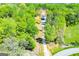 Aerial view of home nestled within dense trees, featuring a long private drive at 90 Ayers Rd, Bowdon, GA 30108