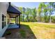 Spacious backyard with a well-maintained lawn and lovely green trees at 90 Ayers Rd, Bowdon, GA 30108