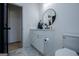 Bathroom featuring white cabinets, marble counters and floors, and round mirror at 90 Ayers Rd, Bowdon, GA 30108