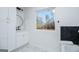 Modern bathroom featuring a white vanity, striking black accents, and a large window with scenic views at 90 Ayers Rd, Bowdon, GA 30108