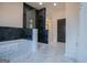 Elegant bathroom with a glass-enclosed shower, black geometric tiling, and contemporary fixtures at 90 Ayers Rd, Bowdon, GA 30108