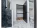 Modern bathroom featuring a walk-in closet, toilet, and stylish bathtub with black geometric tiling at 90 Ayers Rd, Bowdon, GA 30108