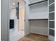 Bathroom featuring sleek black accents, leading into a modern closet with custom shelving at 90 Ayers Rd, Bowdon, GA 30108