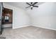 Neutral bedroom featuring carpeted floor, ceiling fan, light-colored walls, and open doorway at 90 Ayers Rd, Bowdon, GA 30108