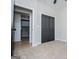 Neutral bedroom featuring carpet, closet, and doorway at 90 Ayers Rd, Bowdon, GA 30108