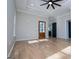 Bright bedroom featuring hardwood floors, tray ceiling and two entryway doors at 90 Ayers Rd, Bowdon, GA 30108