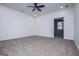 Spacious bonus room featuring neutral carpeting, a ceiling fan, and a sunlit adjacent room at 90 Ayers Rd, Bowdon, GA 30108