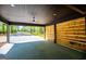Attached carport with wood slat privacy feature and ceiling fan at 90 Ayers Rd, Bowdon, GA 30108