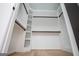 Spacious walk-in closet features custom shelving and black rods for optimal storage and organization at 90 Ayers Rd, Bowdon, GA 30108