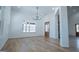 Bright dining room with modern light fixture, large windows, and hardwood floors at 90 Ayers Rd, Bowdon, GA 30108