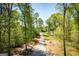 Long gravel driveway leading to a single-Gathering home among lush trees, showing privacy and a sense of seclusion at 90 Ayers Rd, Bowdon, GA 30108