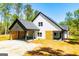 Picturesque two-story home with a spacious carport and wood slat privacy feature at 90 Ayers Rd, Bowdon, GA 30108