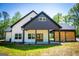 Beautiful modern farmhouse featuring a covered patio, open carport, and a light-filled, two-story design at 90 Ayers Rd, Bowdon, GA 30108