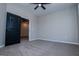 Bedroom featuring a modern ceiling fan, carpeting, and a hallway view at 90 Ayers Rd, Bowdon, GA 30108