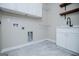 Laundry room featuring white cabinets and tile floors at 90 Ayers Rd, Bowdon, GA 30108
