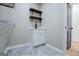 Laundry room featuring white cabinets and wood shelves at 90 Ayers Rd, Bowdon, GA 30108