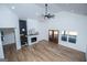 Bright living room with high ceilings, fireplace, wood floors, black accents, and natural light at 90 Ayers Rd, Bowdon, GA 30108