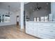 Expansive living area features wood floors, white cabinets, and modern lighting at 90 Ayers Rd, Bowdon, GA 30108