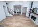 Open-concept living area with a fireplace, breakfast bar, and stairs leading to the second floor at 90 Ayers Rd, Bowdon, GA 30108
