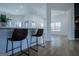 Bright open-concept living space with bar seating and hardwood floors at 90 Ayers Rd, Bowdon, GA 30108