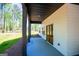 Covered patio showcasing double doors and views of the beautiful, green backyard at 90 Ayers Rd, Bowdon, GA 30108